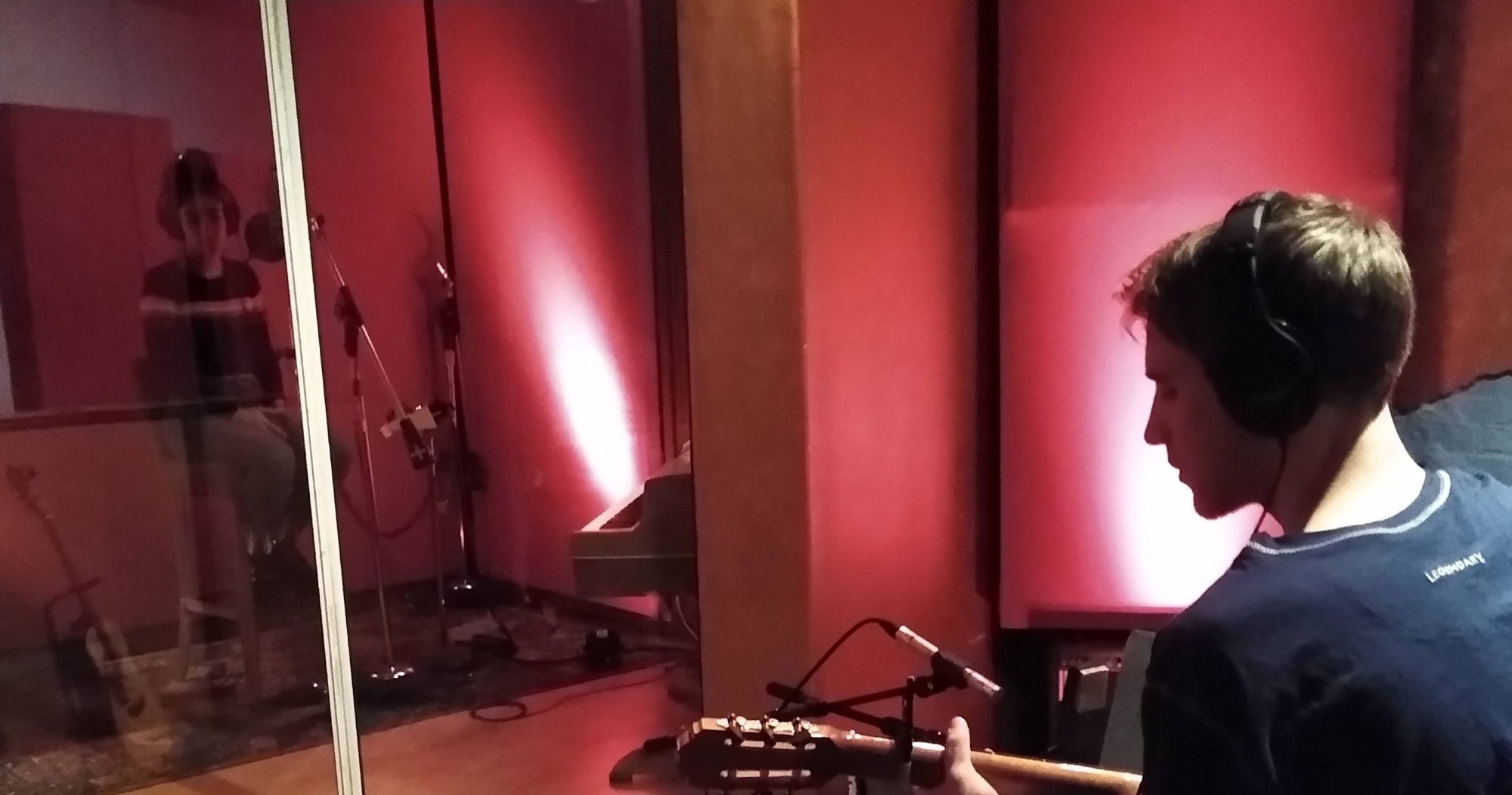Samuel Pickens playing guitar in a live room